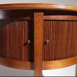 Old mahogany half-moon table with side shutters.