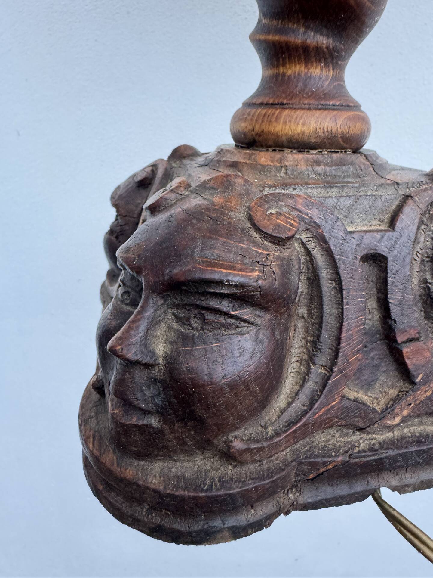 Sculpted wooden lamp with faces, antique.