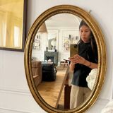 Oval mirror in antique gilded wood