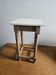 Antique stool in raw wood and off-white.