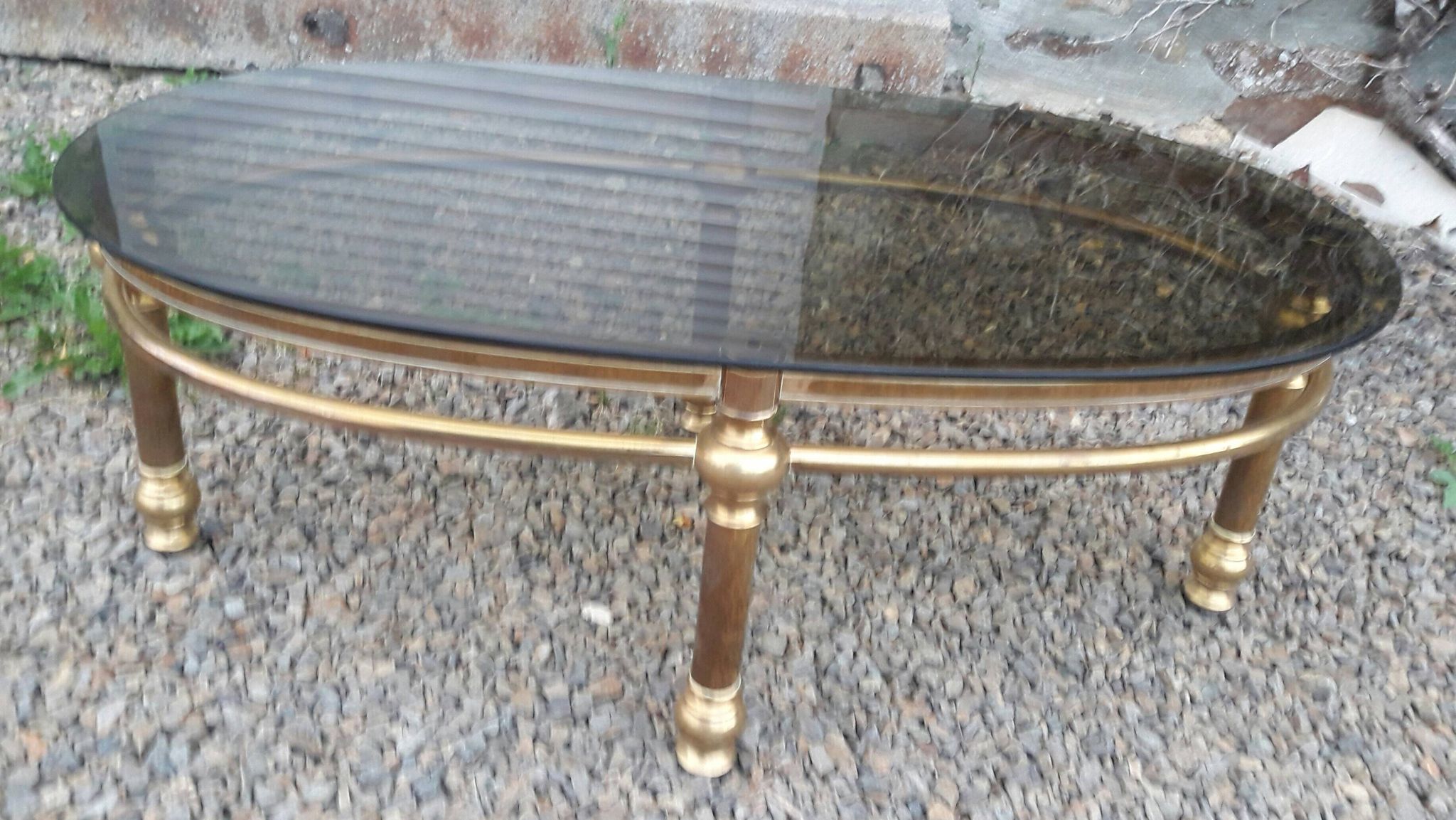 Oval coffee table in gilded brass and smoked glass 1970