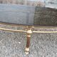 Oval coffee table in gilded brass and smoked glass 1970