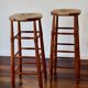 Antique wooden bar stool with a straw seat