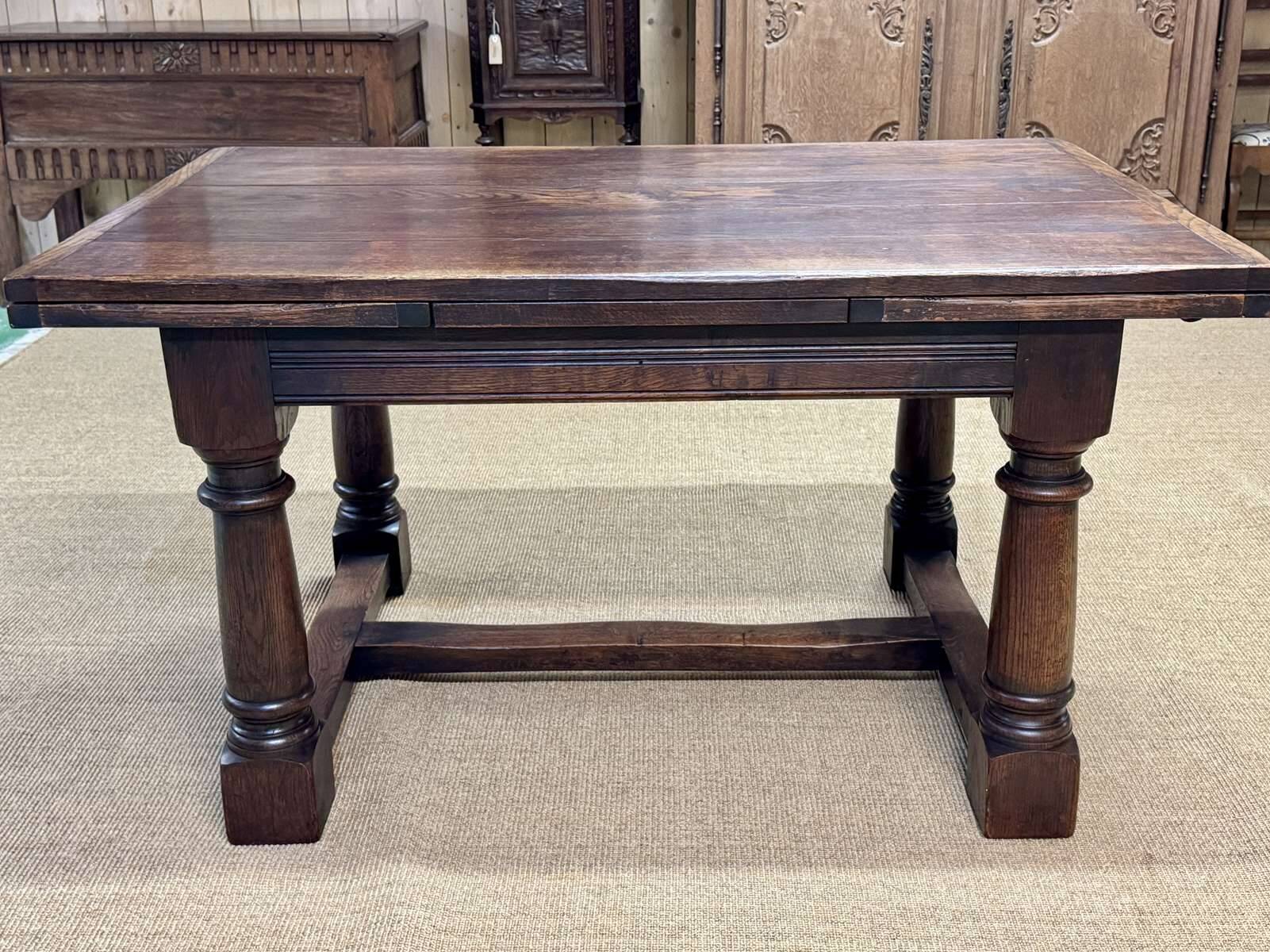 English monastery table with extensions from the late 19th century in elm and oak.