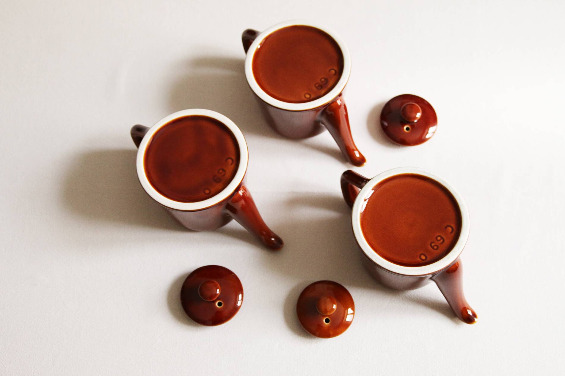 3 brown glazed ceramic teapots