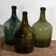 Antique green demijohns (circa 1920). Set of 3 pieces