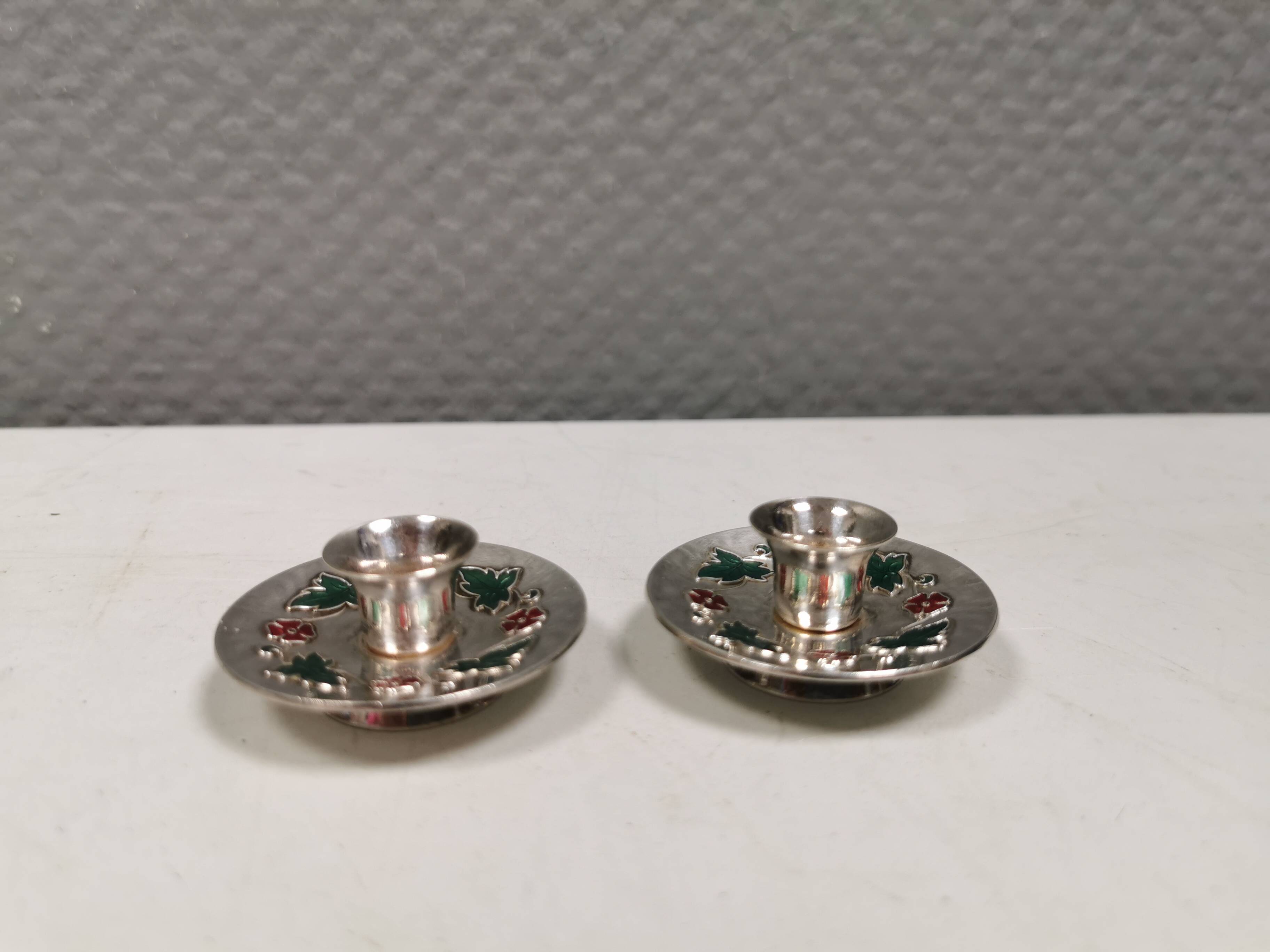 Silver-plated candle holders with inlaid red and green enamel