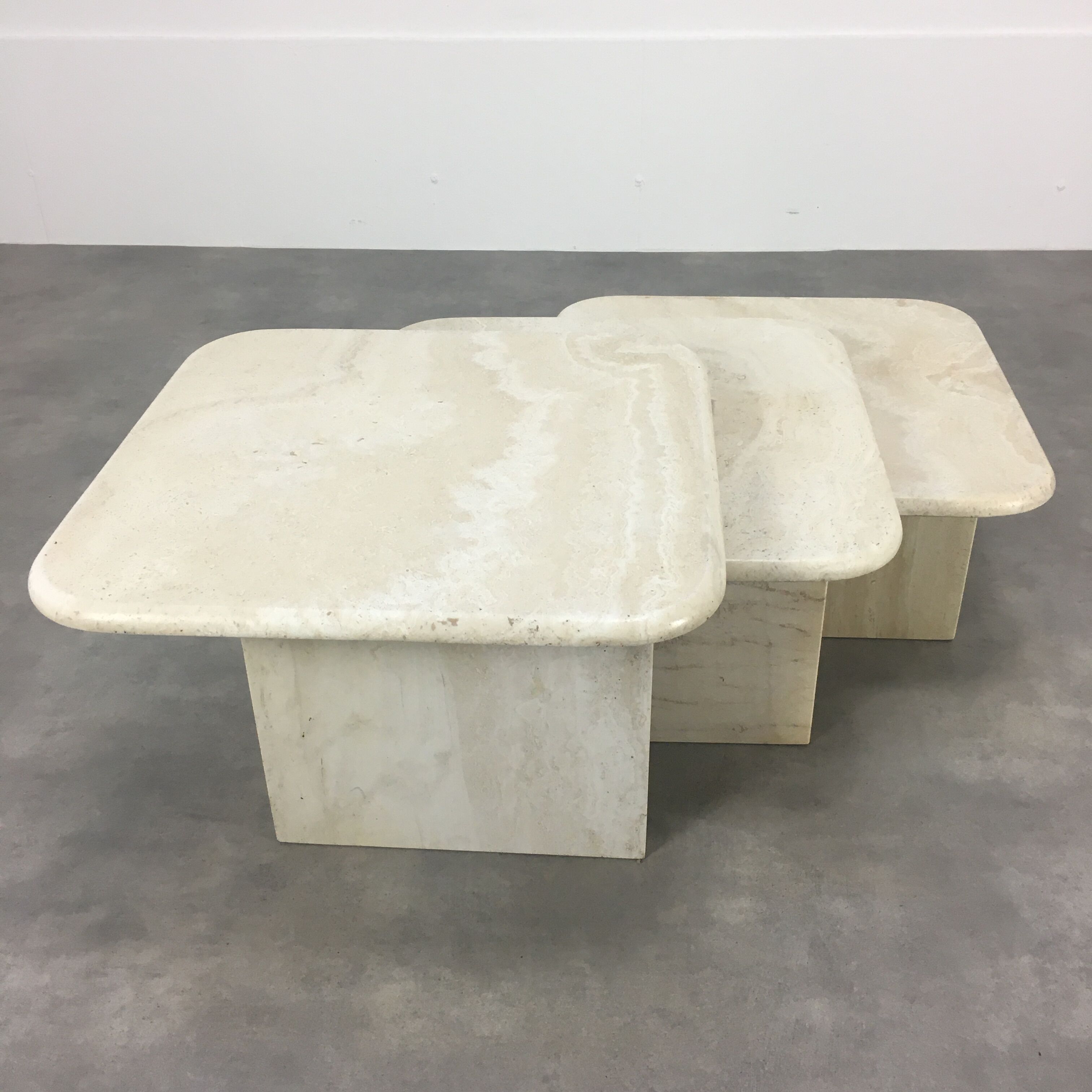 Three travertine trundle coffee tables
