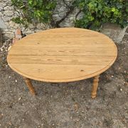 Folding drop-leaf table made of raw solid wood.