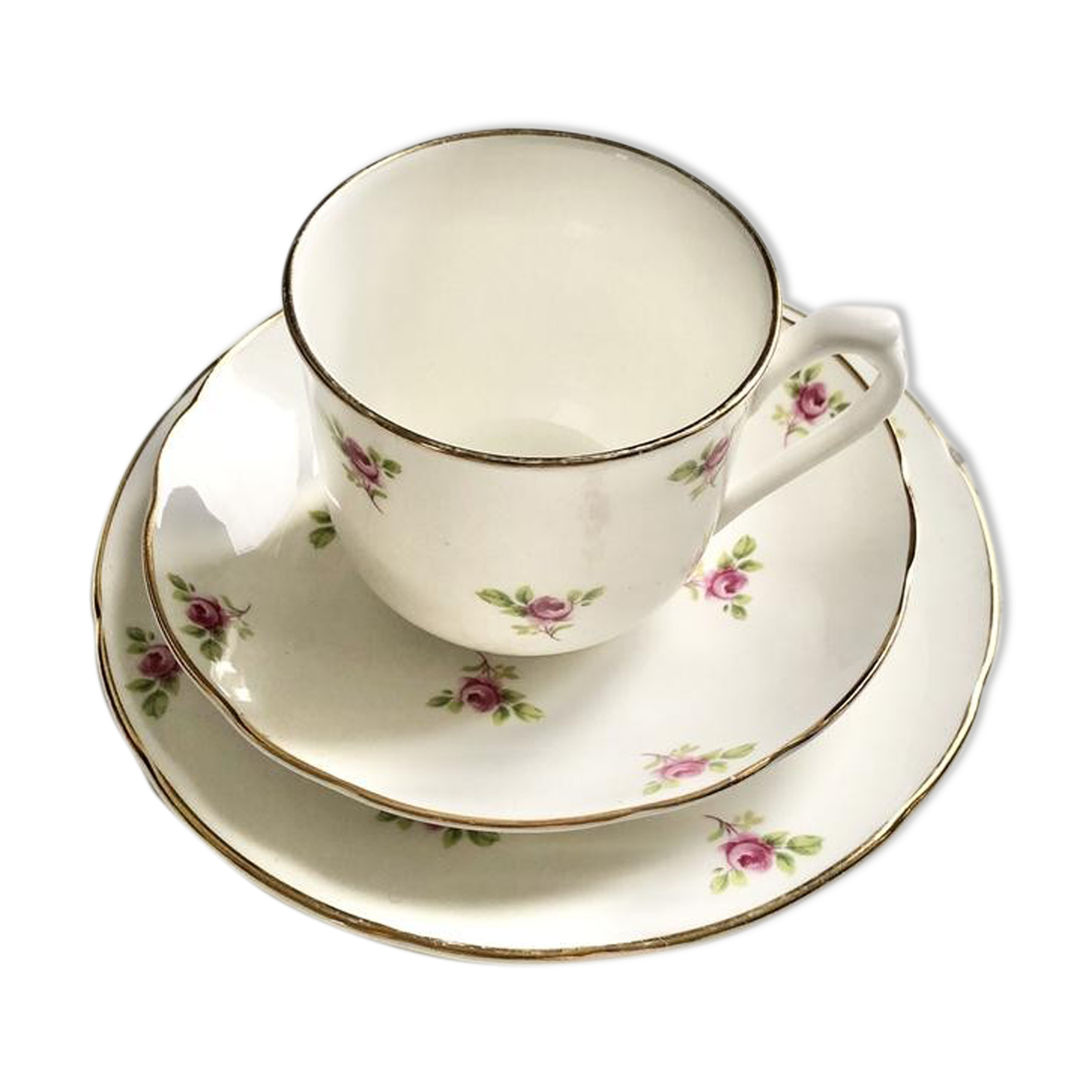 Teacup on its saucer and porcelain cake plate
