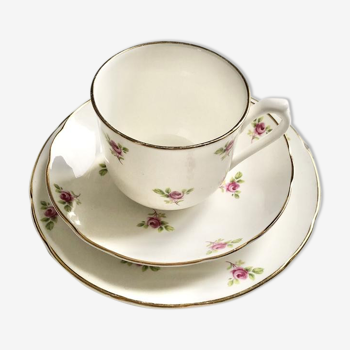 Teacup on its saucer and porcelain cake plate
