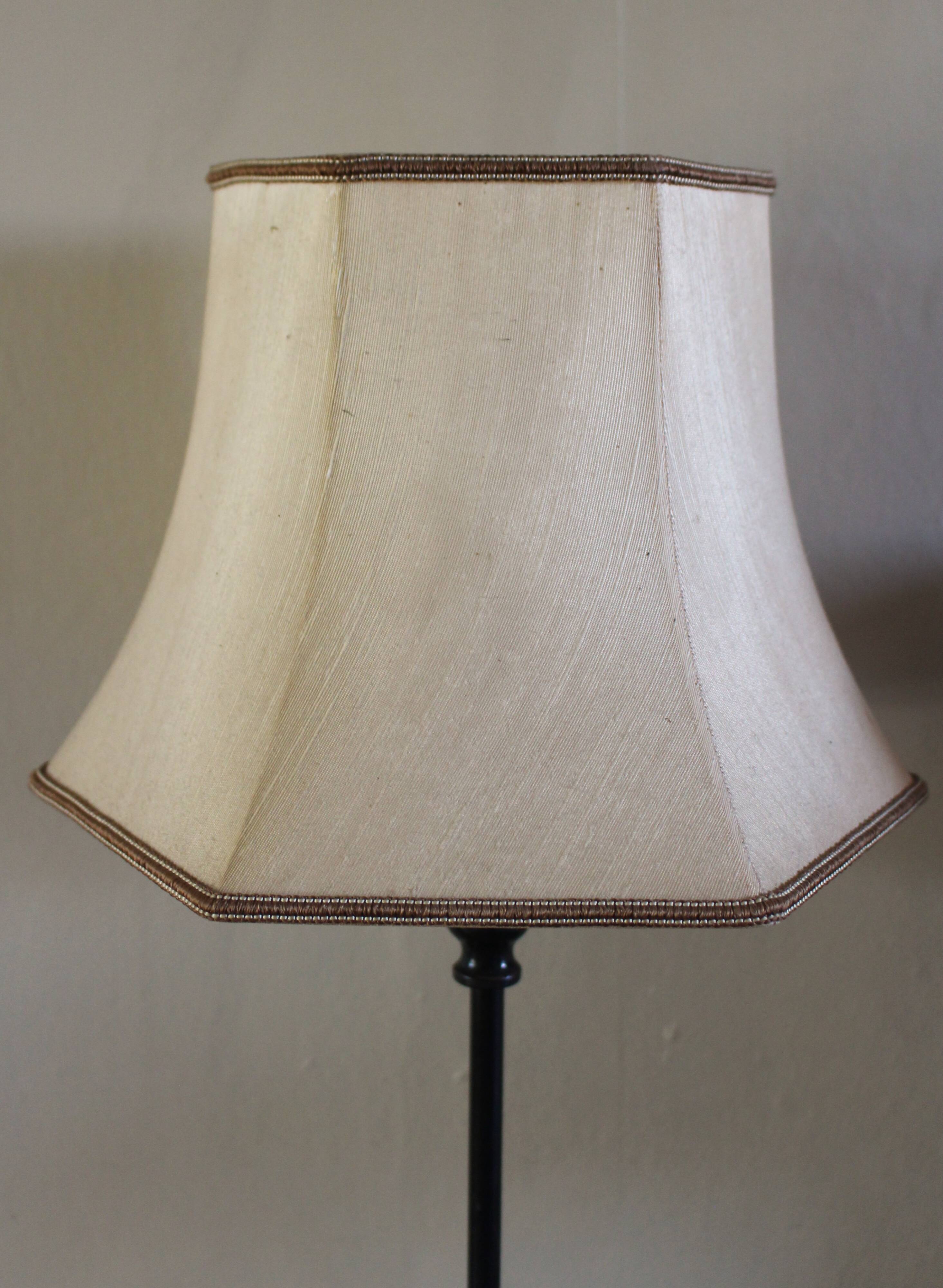 Table lamp with a patinated base and vintage woven shade.