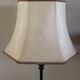 Table lamp with a patinated base and vintage woven shade.