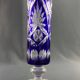 Tubular vase on a pedestal in cut blue Bohemian crystal.