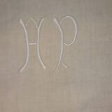 White mestizo sheet with monogram.