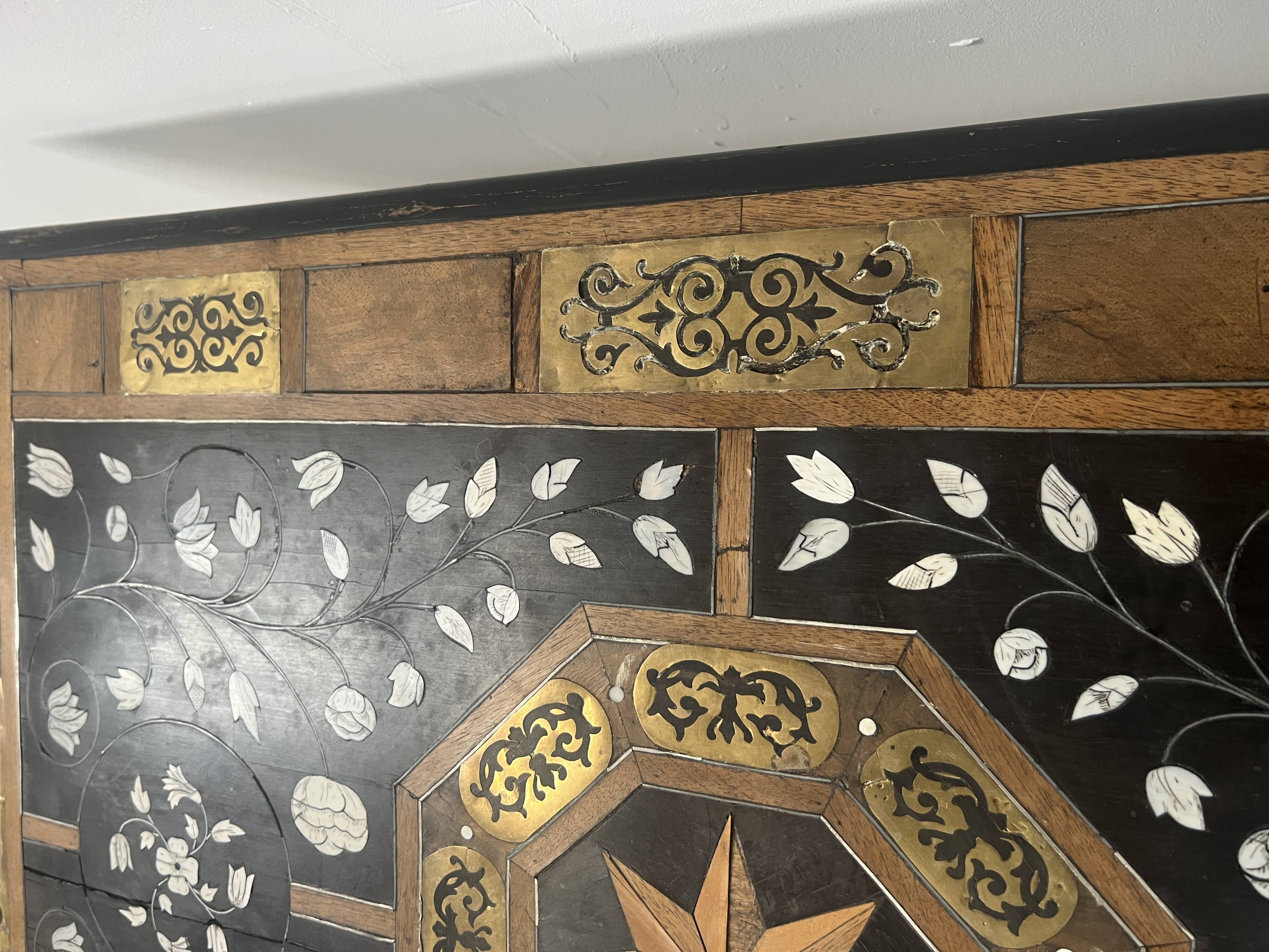 Blackened wood display table with marquetry top, Spain, 19th century.