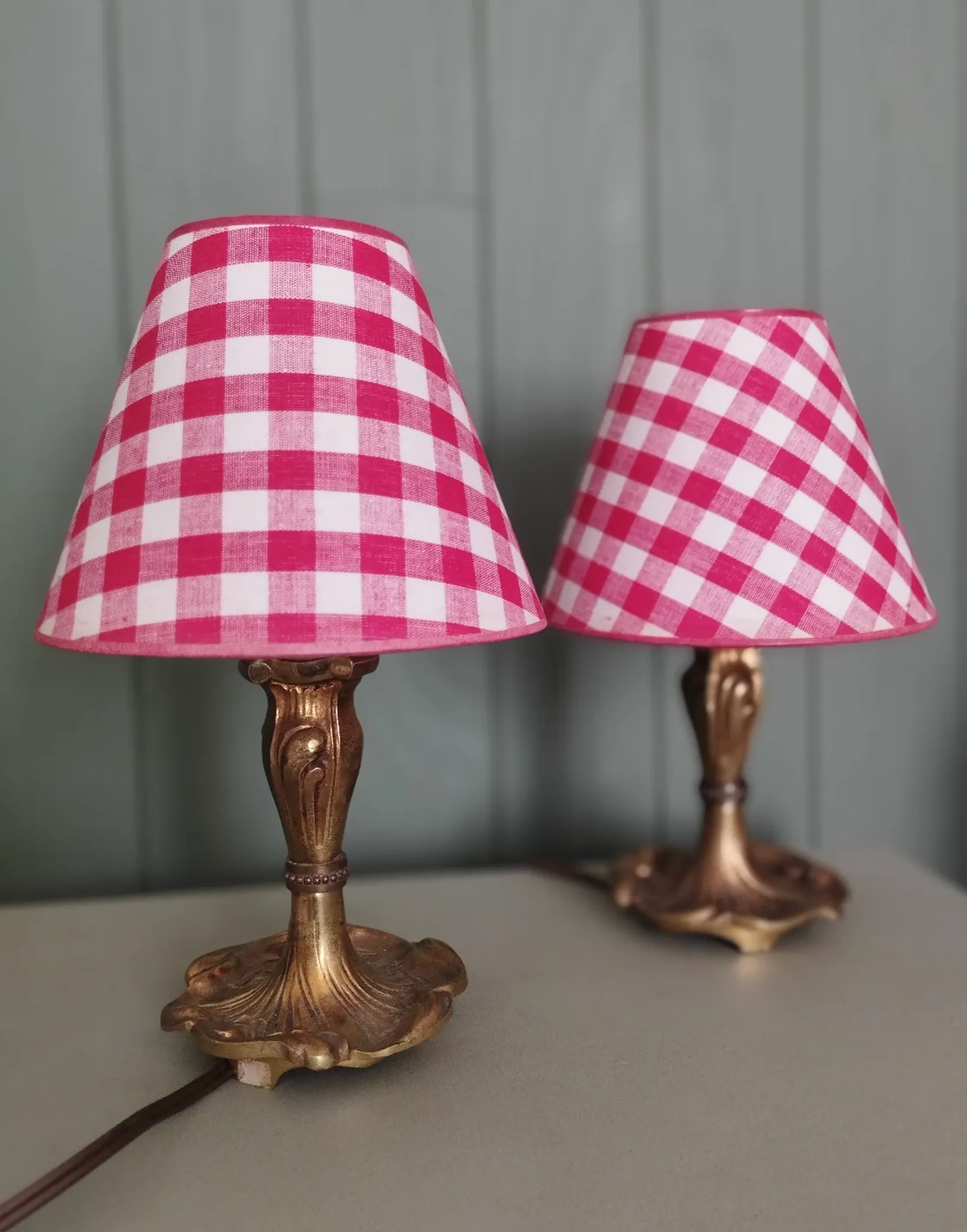 Pair of small lamps in gilded bronze by Petitot and red gingham lampshades.
