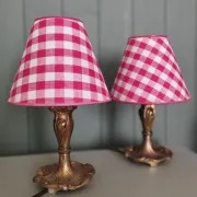 Pair of small lamps in gilded bronze by Petitot and red gingham lampshades.
