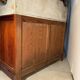 Antique wood and marble kitchen sideboard with carved backsplash