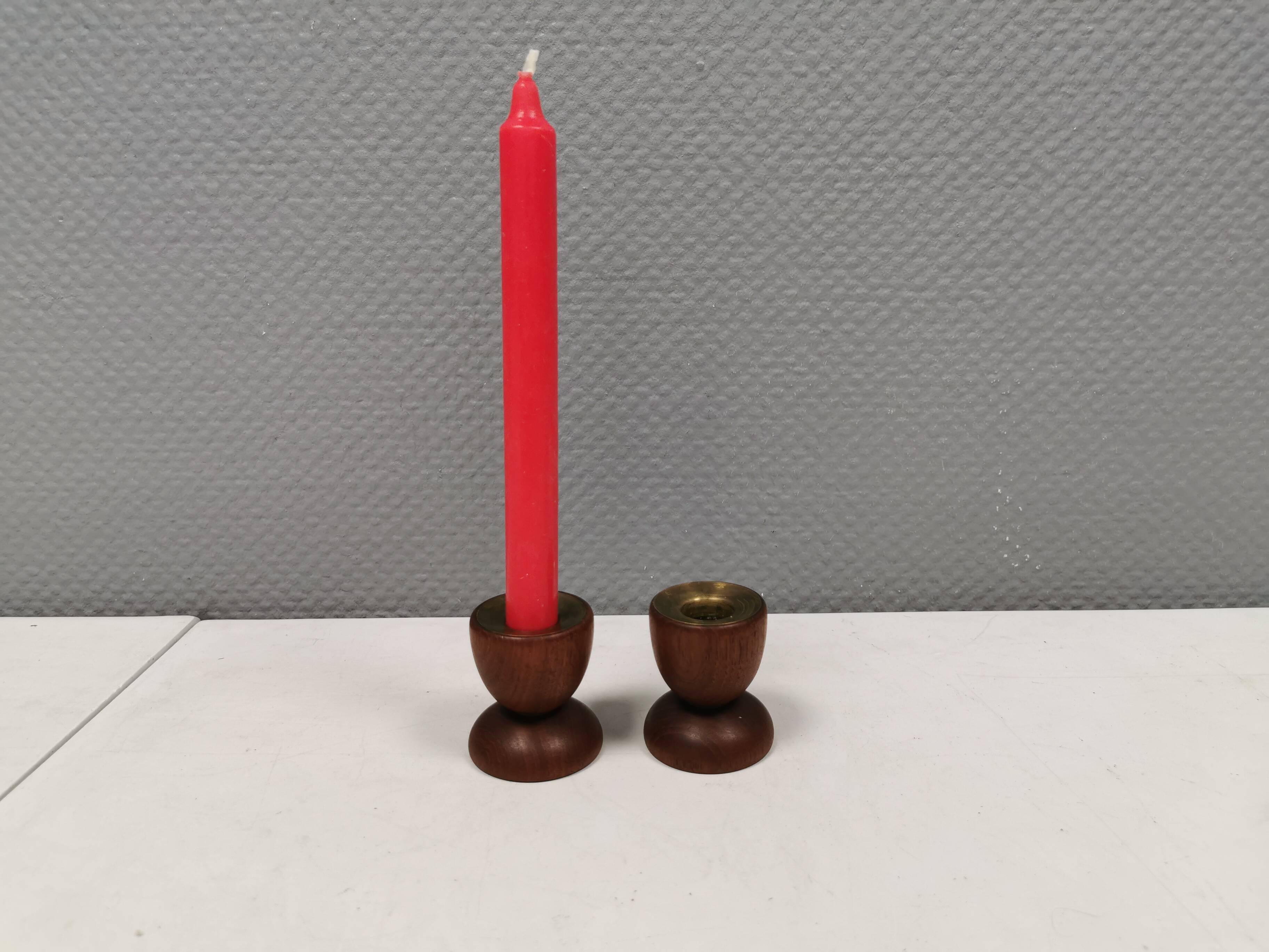 Two beautiful teak candle holders with brass inserts.