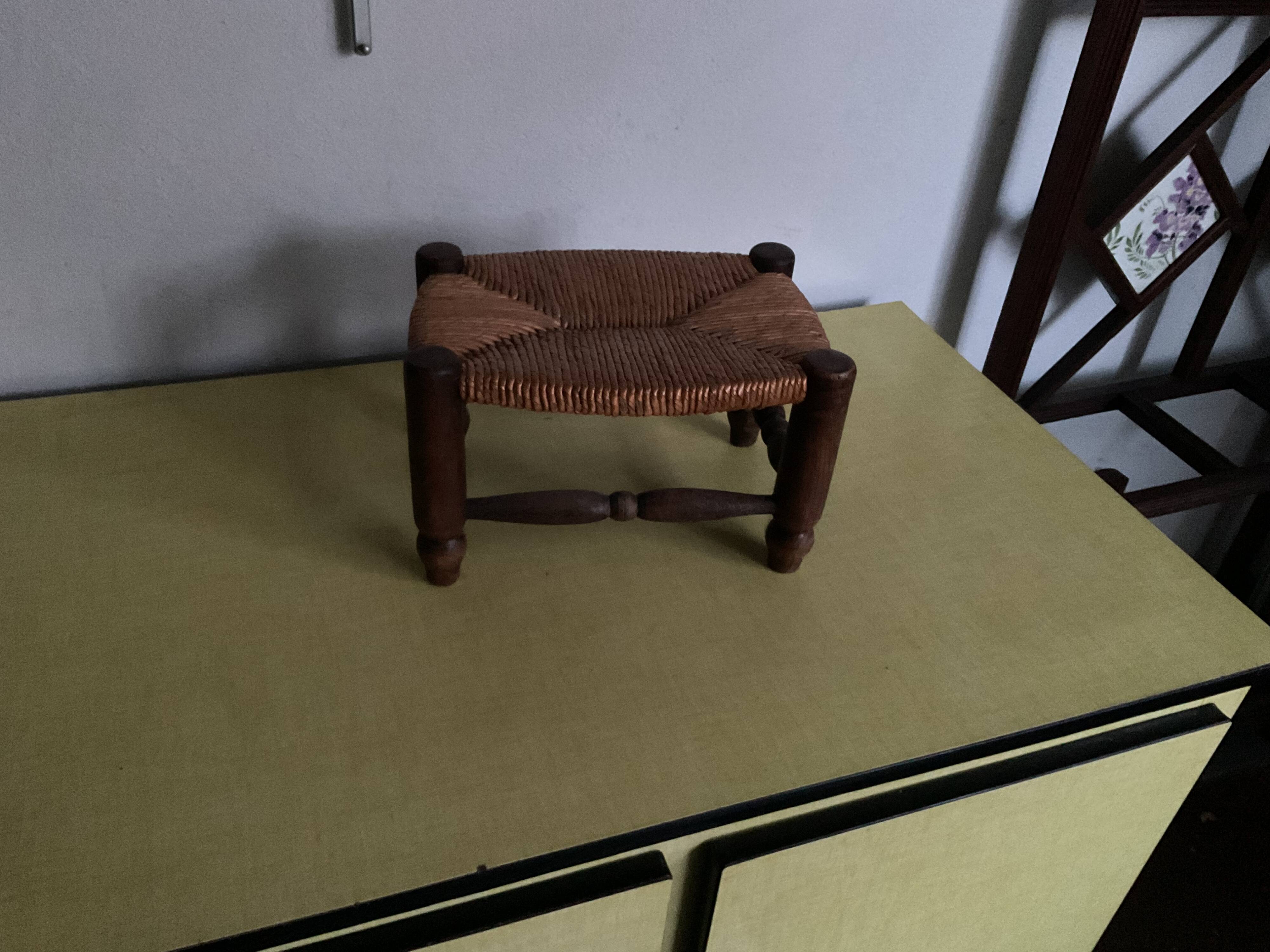 Turned wooden stool and straw