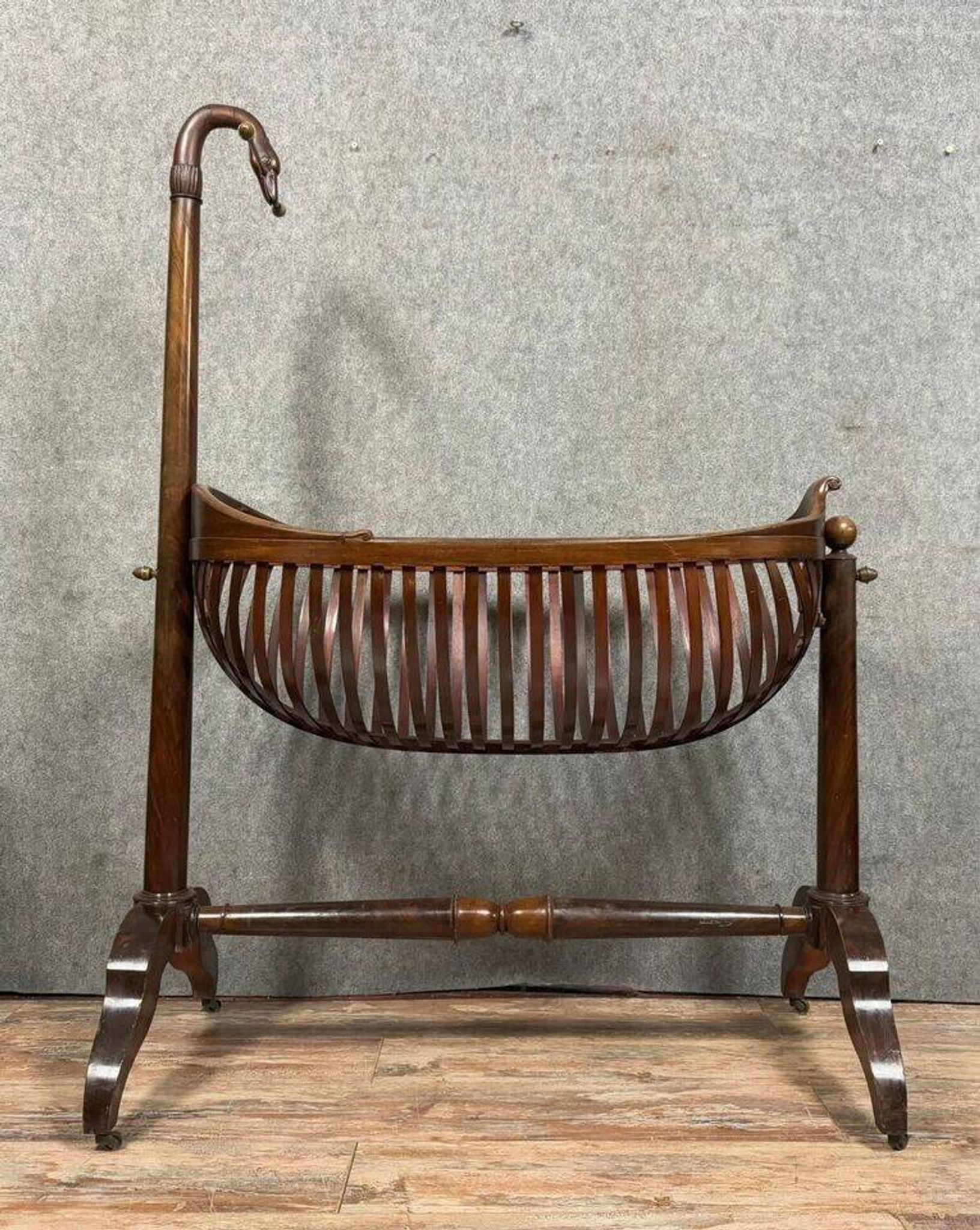 Empire style mahogany cradle with a swan neck, shaped like a cradle, circa 1810