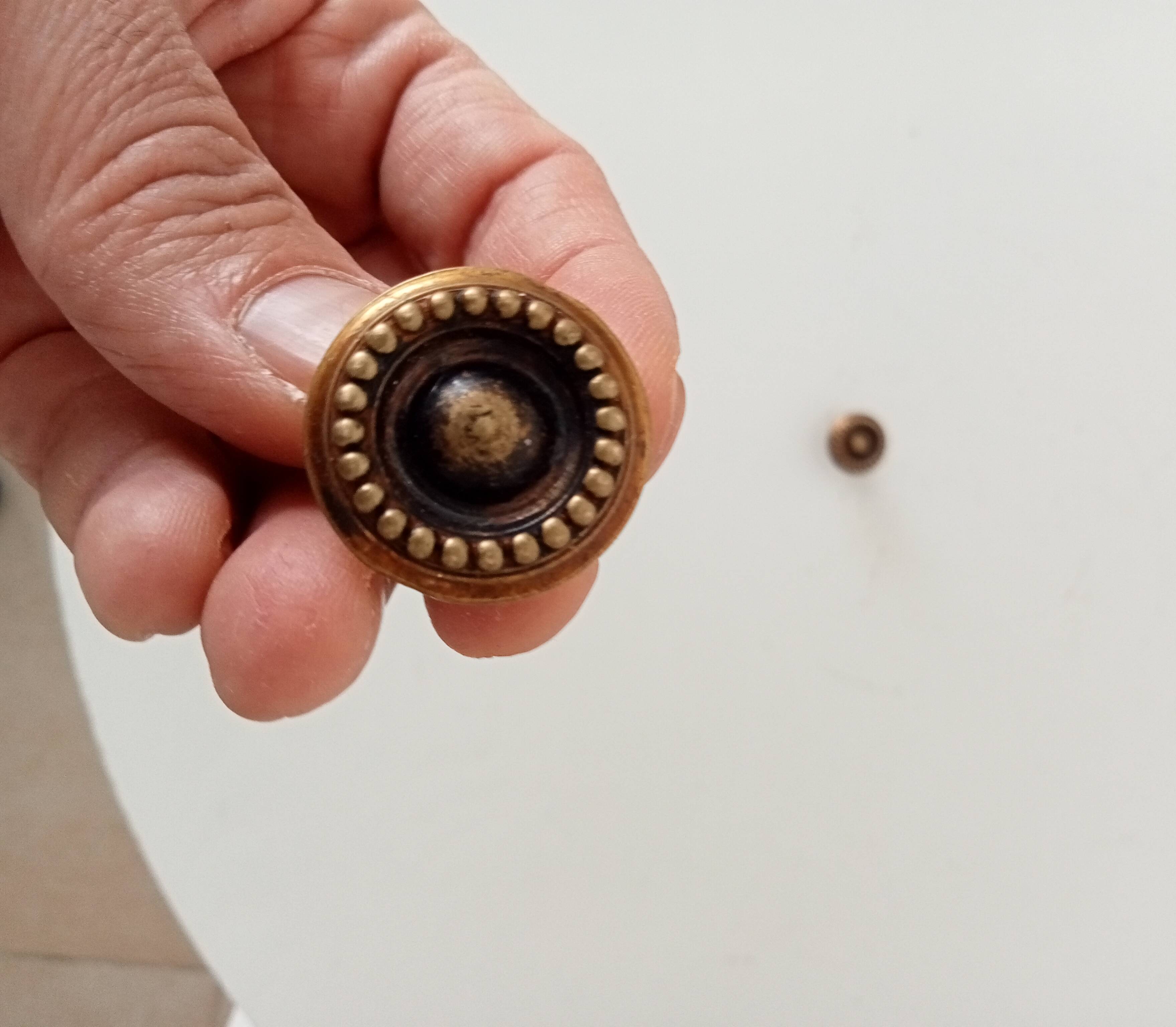 Pair of antique furniture knobs in gilded brass.