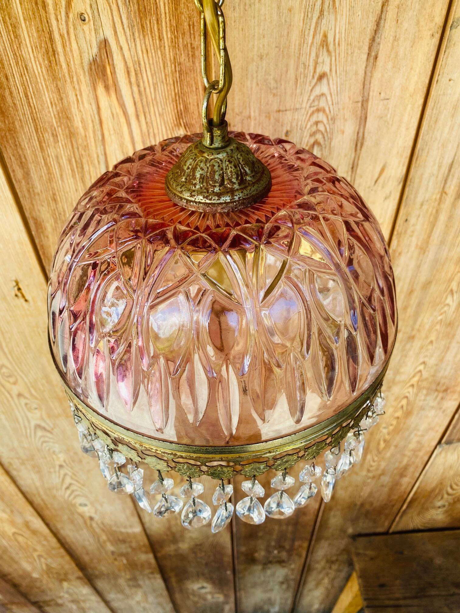 Antique pink glass pendant light with tassels.