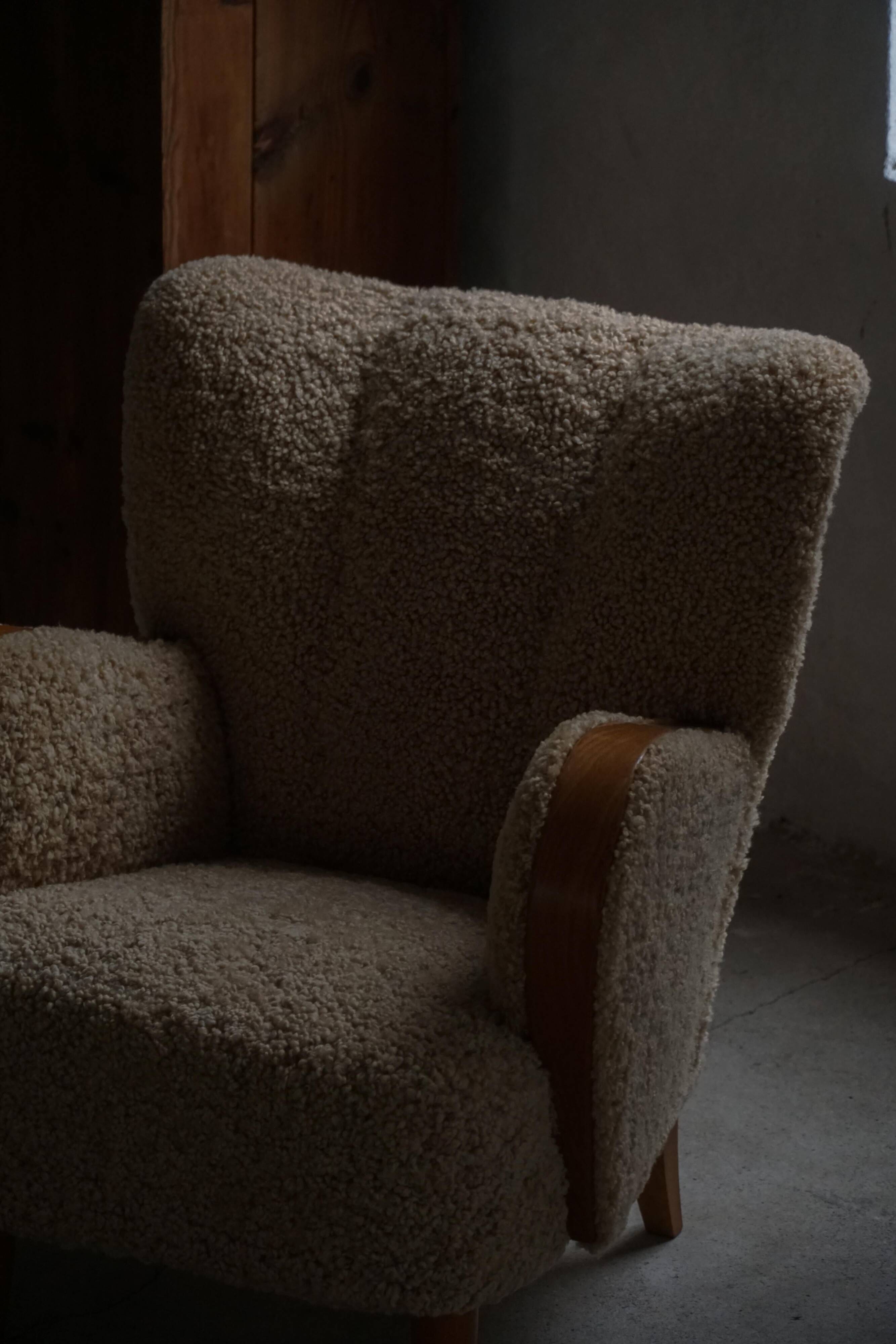 Pair of Danish Art Deco modern lounge chairs in sheepskin with lambswool and elm, 1940s.