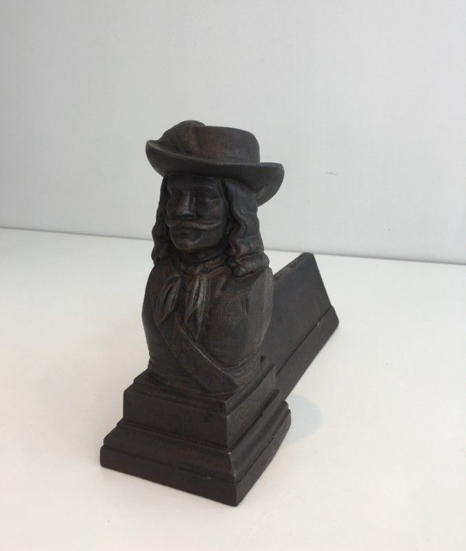 Pair of cast iron andirons in the likeness of a musketeer