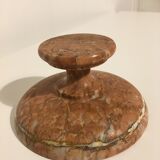 Empty pocket on foot in red marble