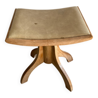 Vintage natural wood stool with light yellow faux leather seat and crossed splayed base