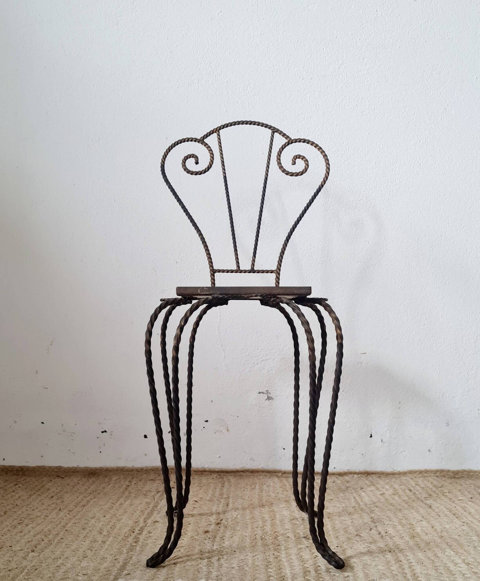 Small chair / stool in twisted wrought iron and floral ceramic.
