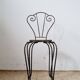 Small chair / stool in twisted wrought iron and floral ceramic.