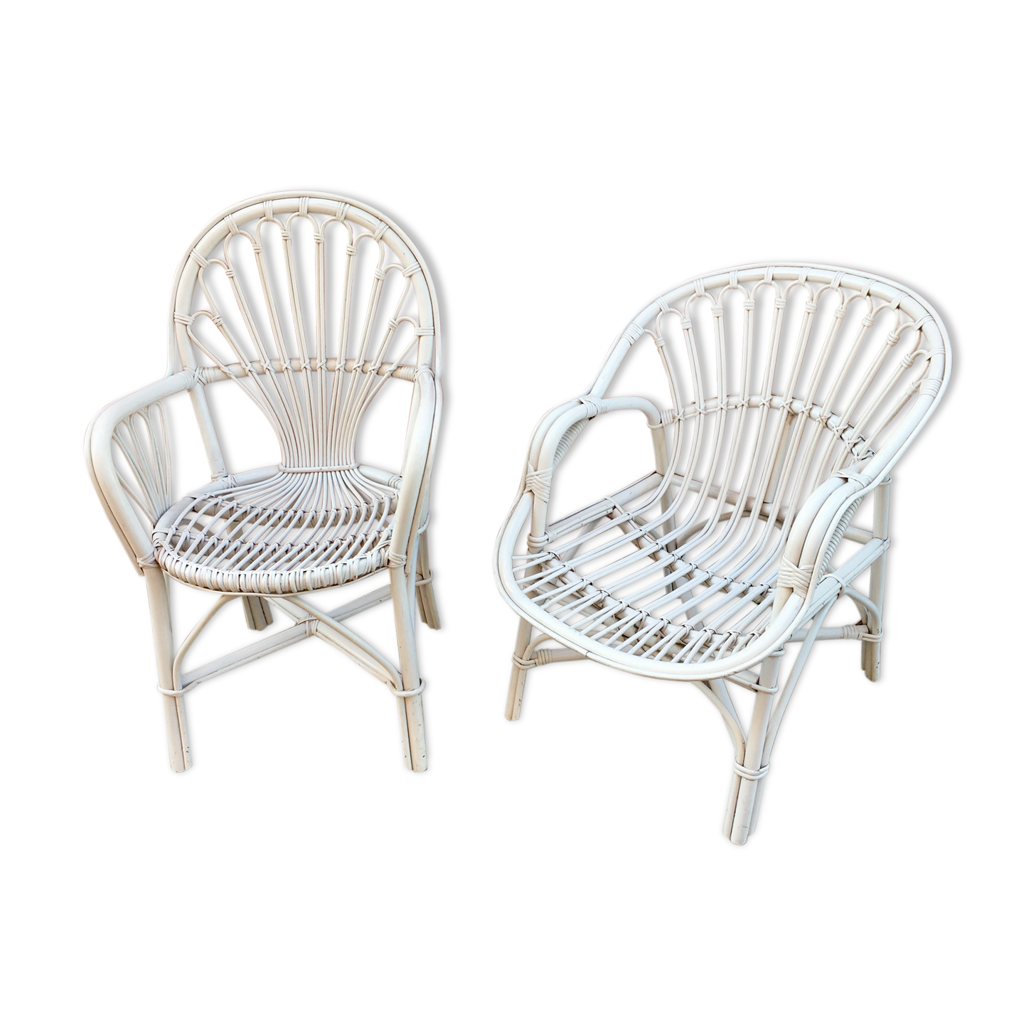 Two white rattan armchairs
