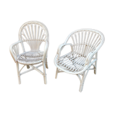 Two white rattan armchairs