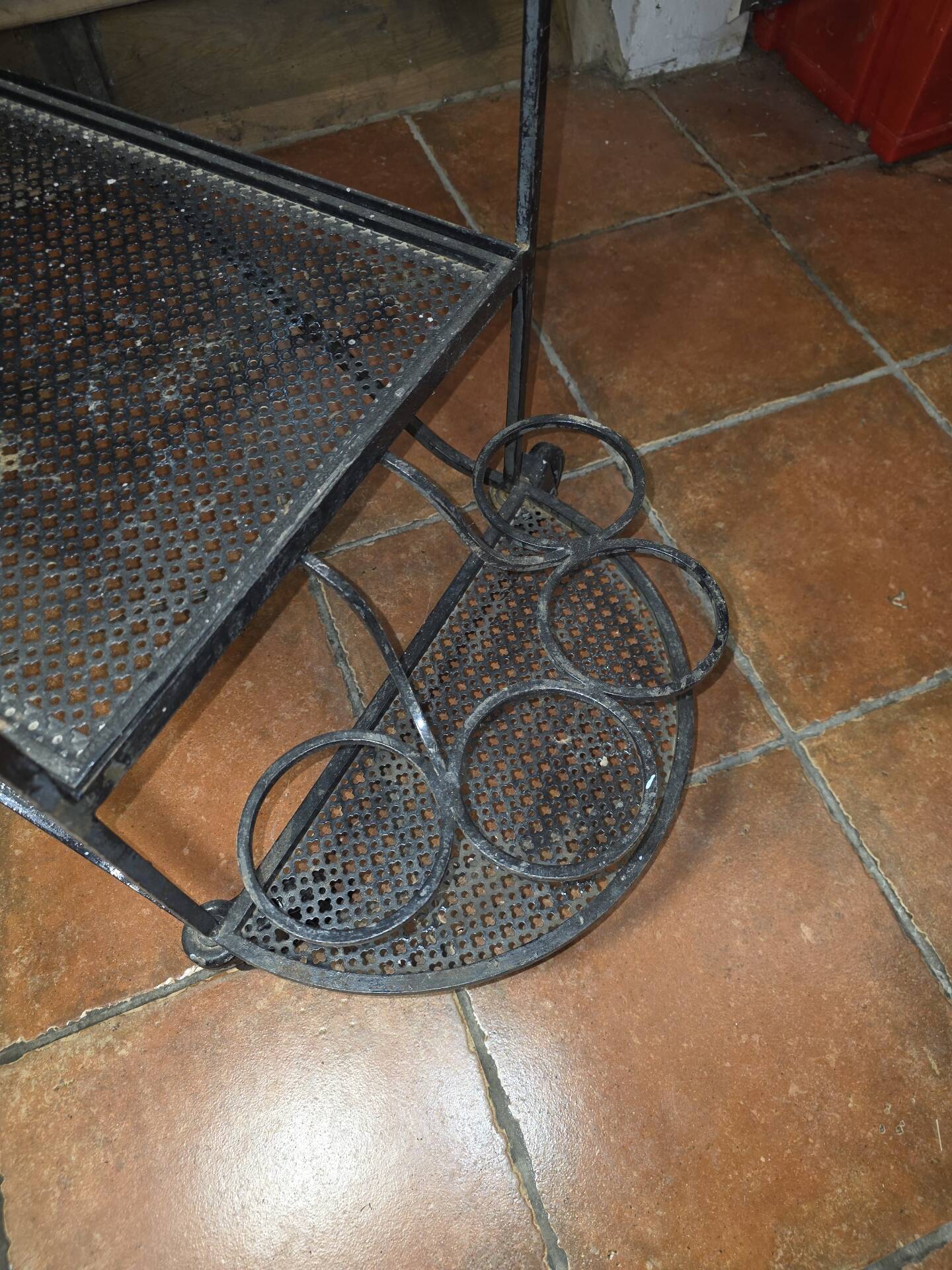 Perforated wrought iron rolling dessert trolley