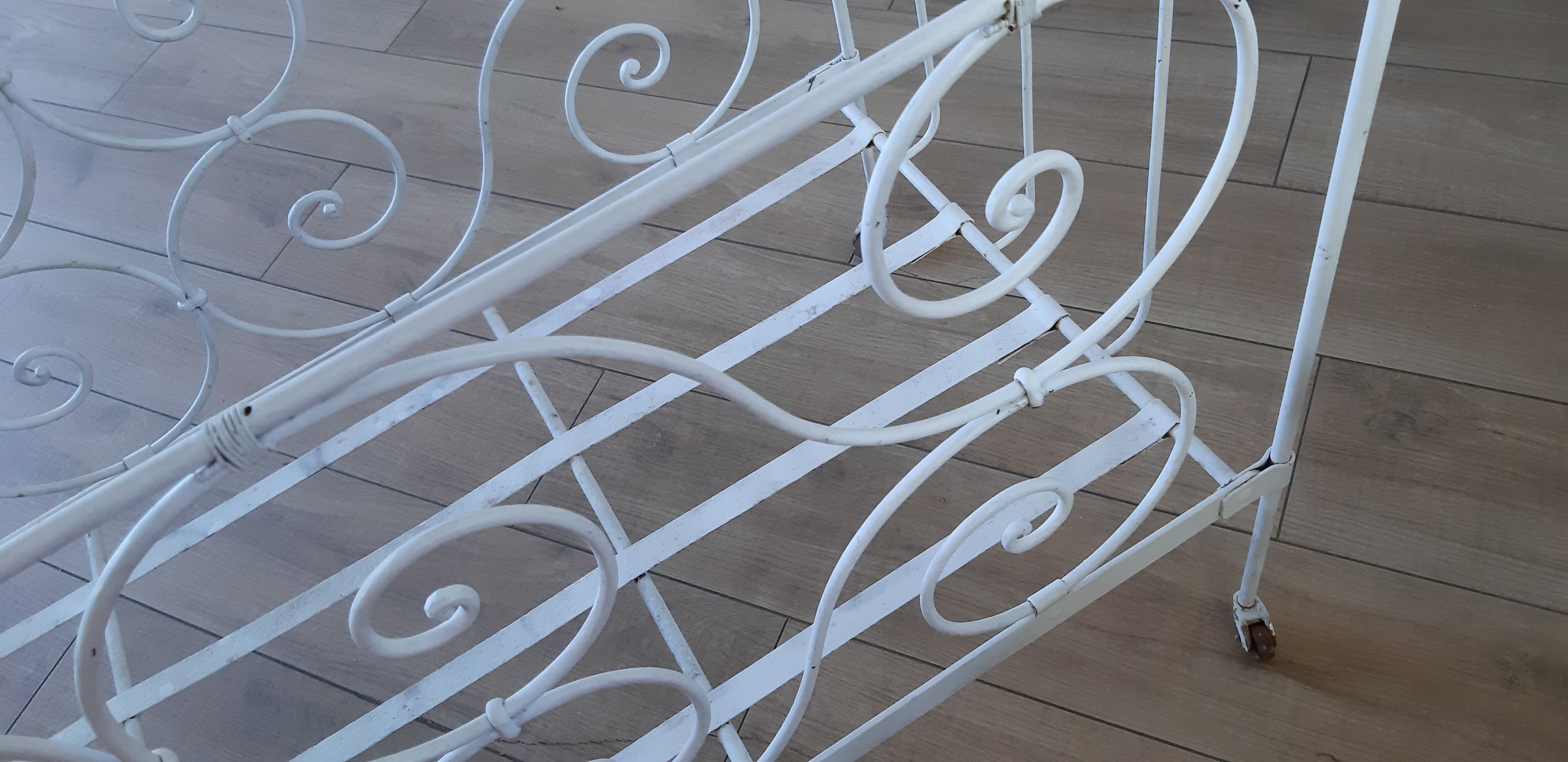 Wrought iron baby bed. Or bench seat of your choice