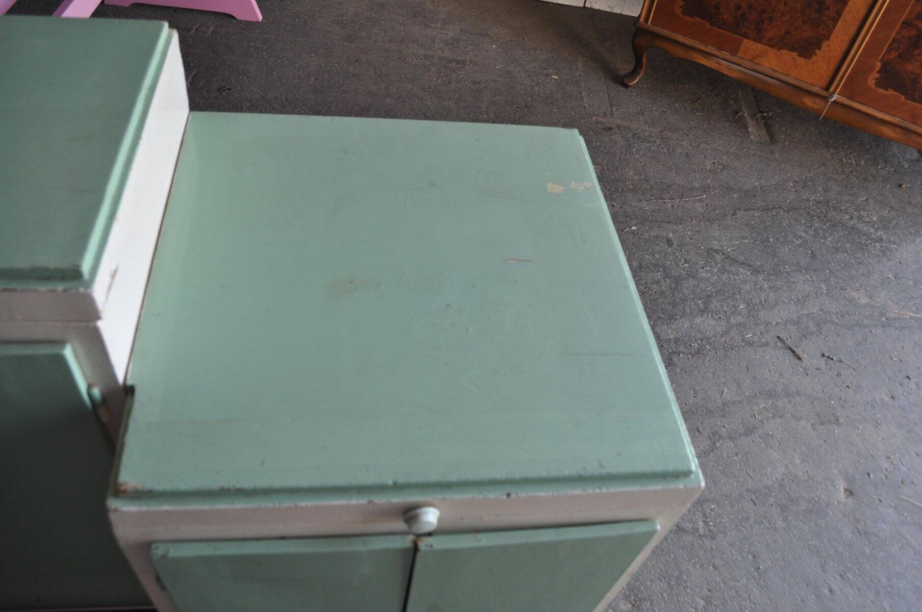 Art Deco washbasin furniture in green and white wood with a glass top, storage from the 1930s.