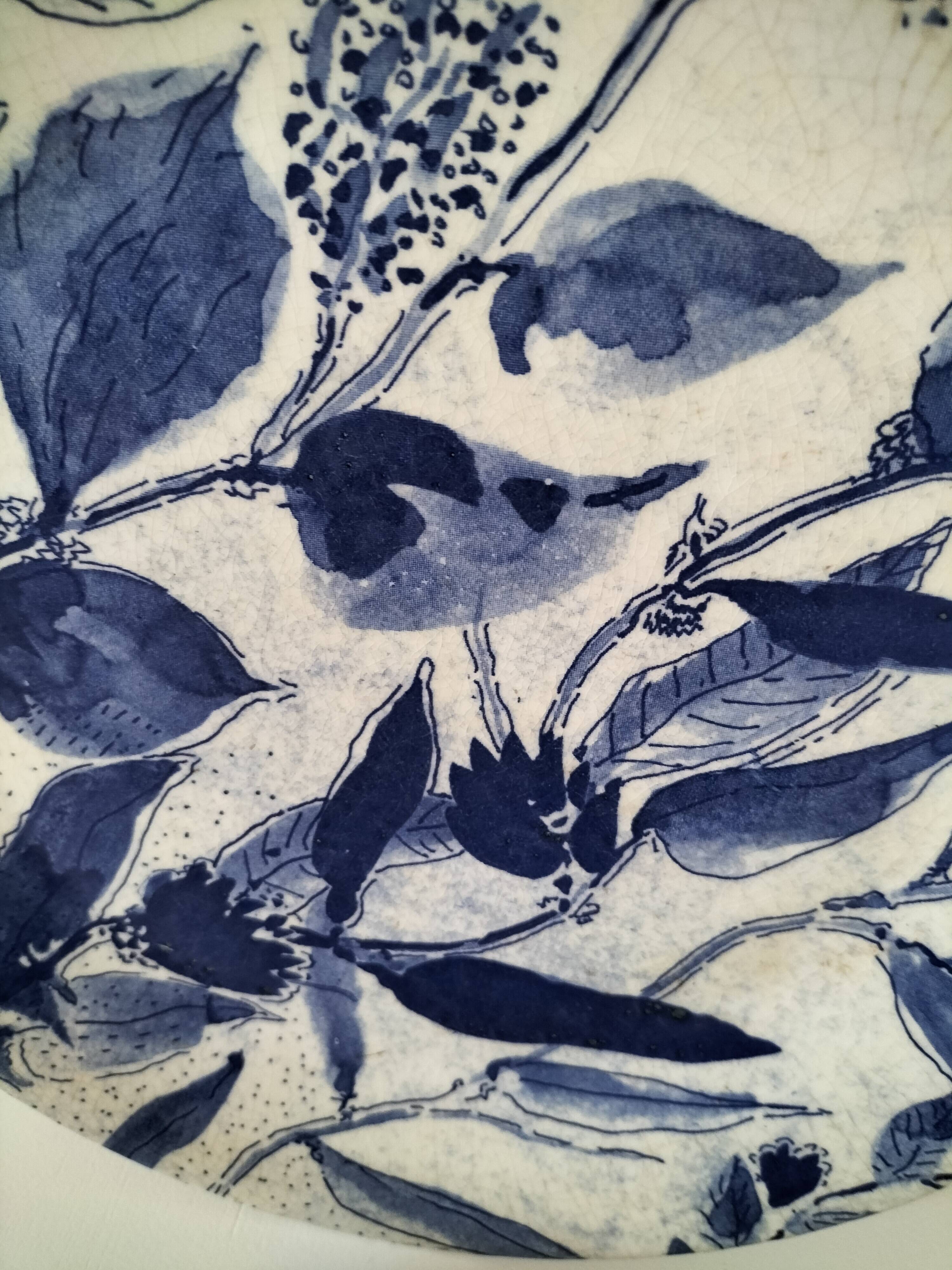 Two flat plates in earthenware with blue floral decoration.