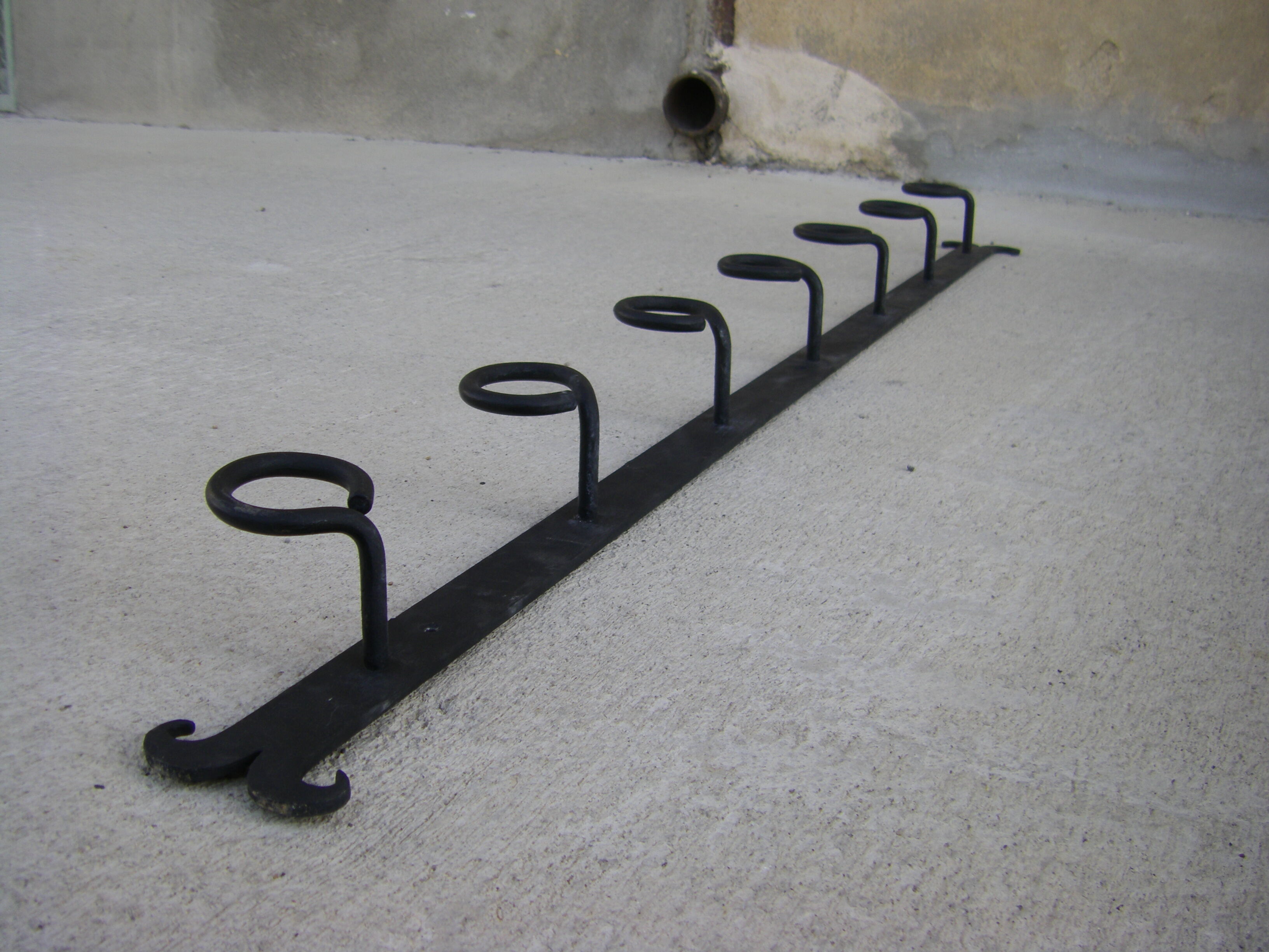Wall-mounted wrought iron coat racks.