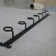 Wall-mounted wrought iron coat racks.