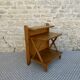 Light wood bedside table with crossbars and 3 shelves, around 1950.