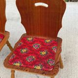 2 curved wood and red fabric chairs