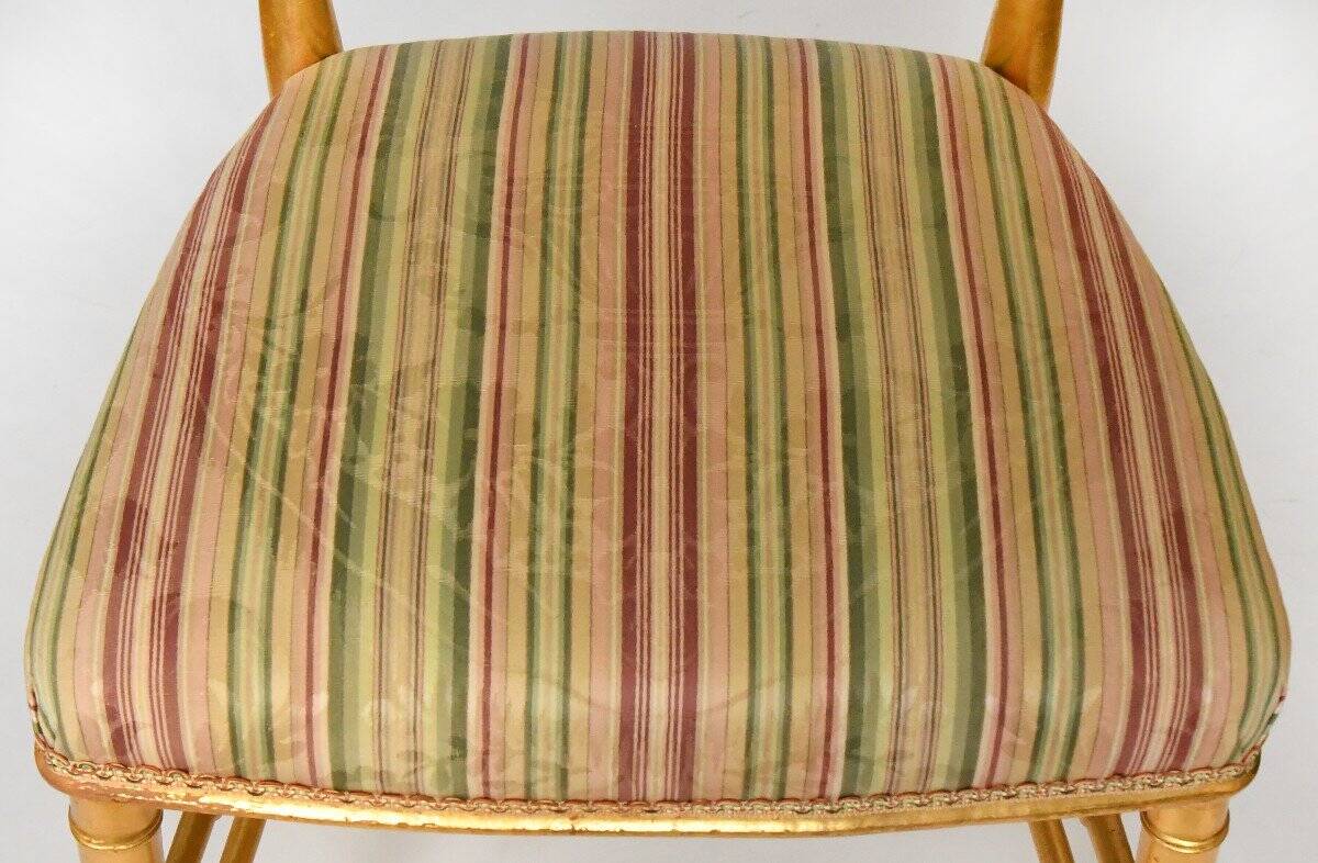 Pair of golden wood chairs in a bamboo style.
