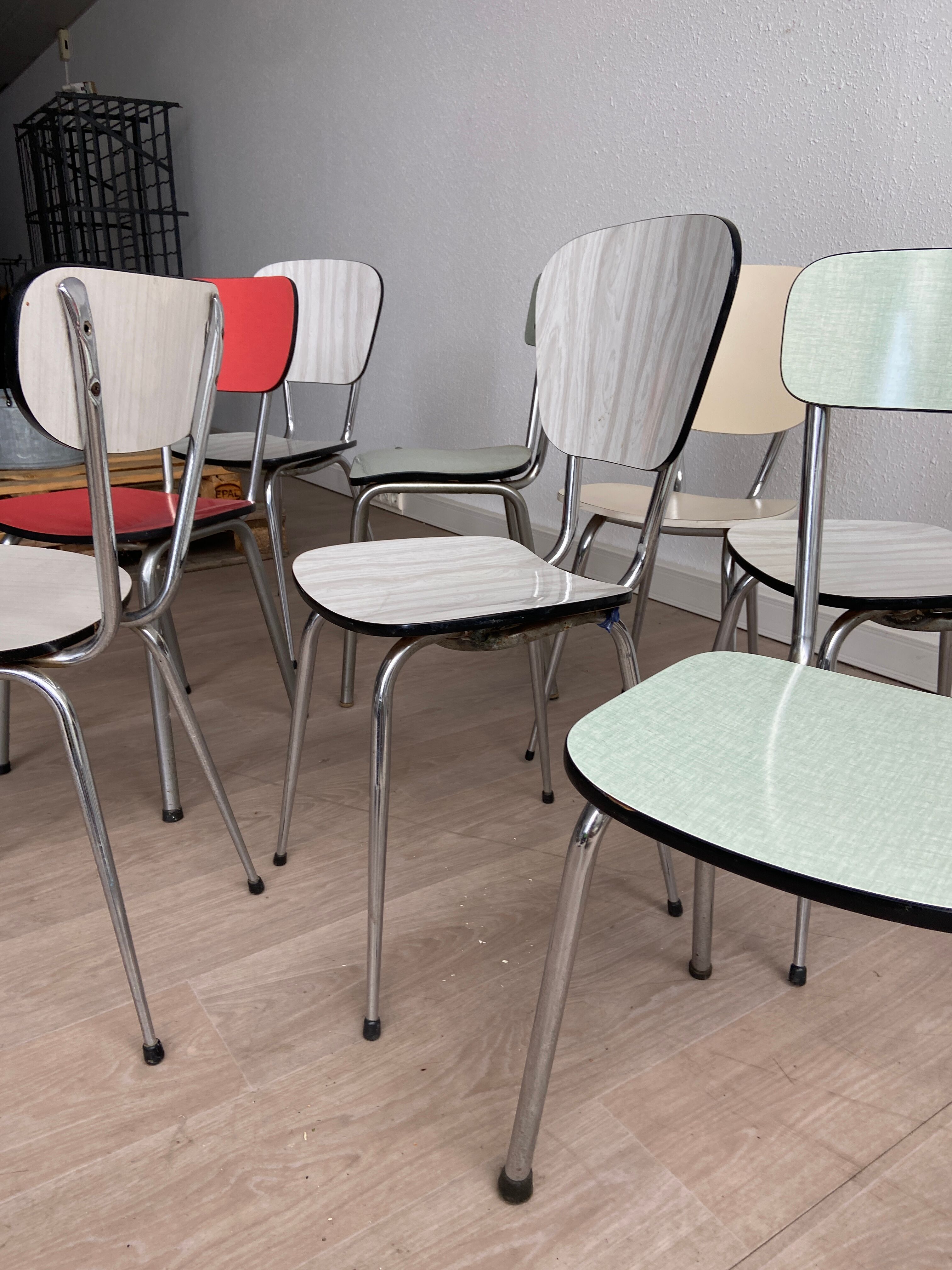 10 mismatched multicolored Formica chairs 60s