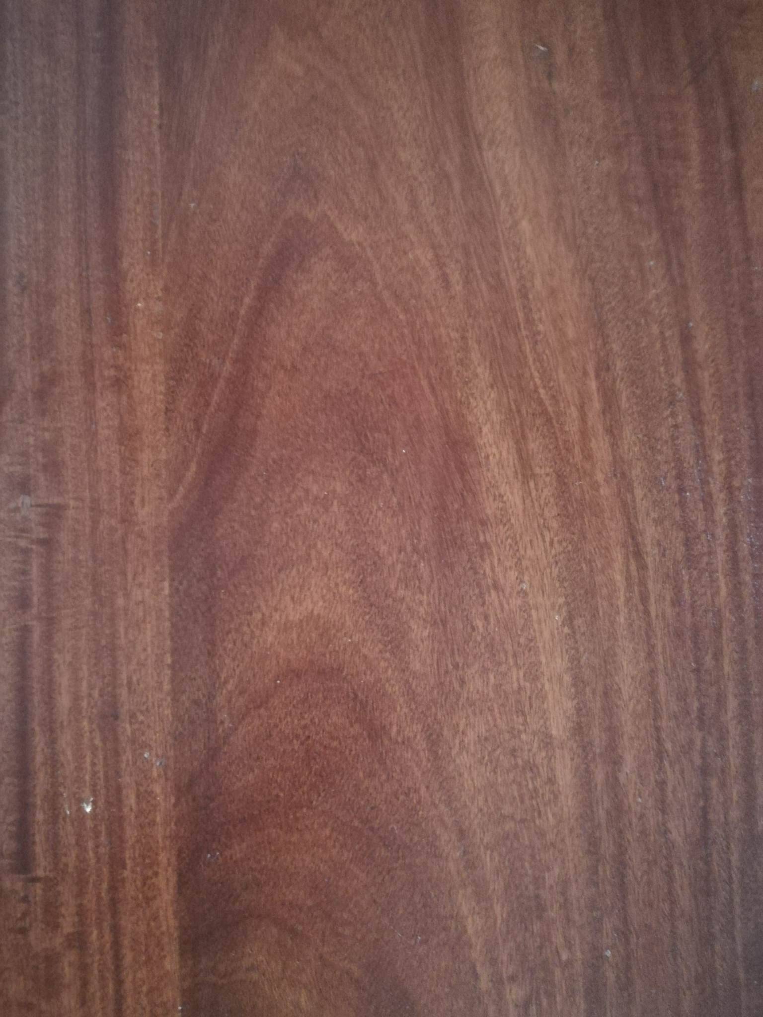 Round wooden table with thin legs