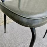 Black metal chairs with khaki faux leather seats, circa 1960.