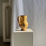 Large antique handmade ochre yellow jug with a pink flower pattern.