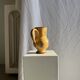 Large antique handmade ochre yellow jug with a pink flower pattern.